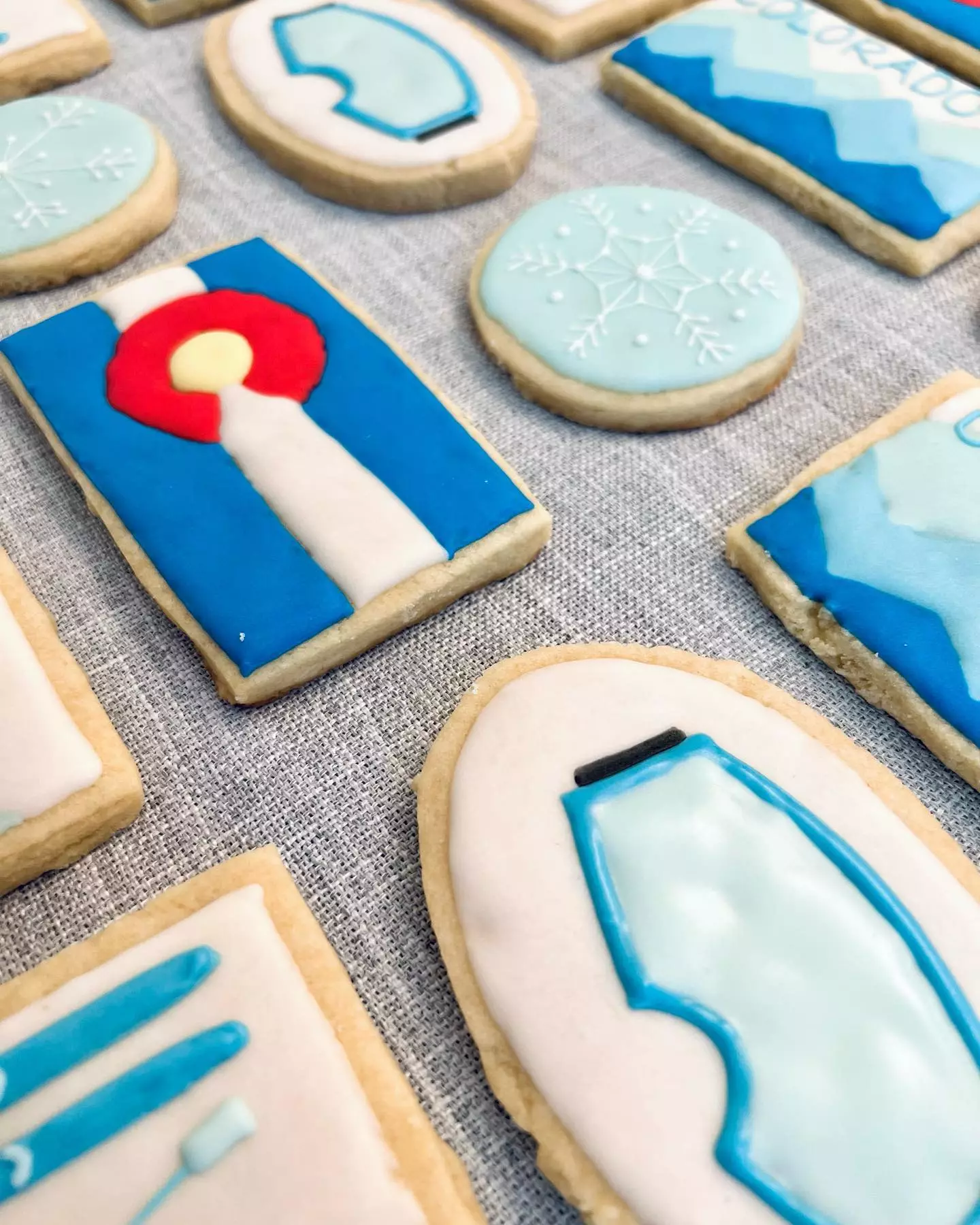 colorado themed cookies including the state flag and skiing-related decorations